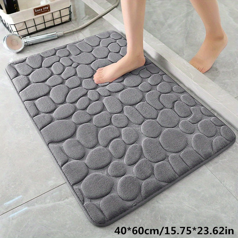 Fluweelzachte polyester badmat met antislip onderkant. Absorbeert water snel voor een droge, veilige badkamer vloermat.