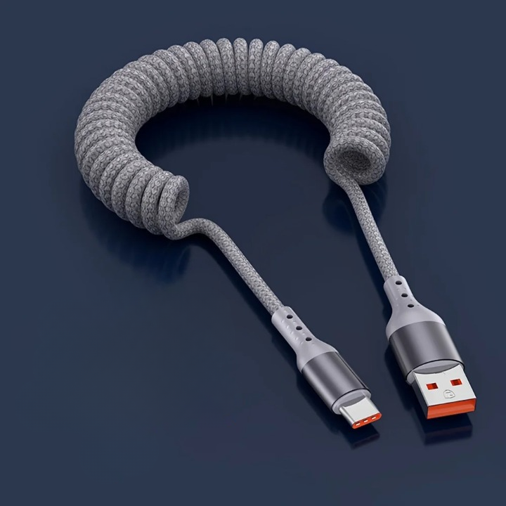 Universele 100W USB-C veerkabel voor snel opladen en dataoverdracht van telefoons en laptops.