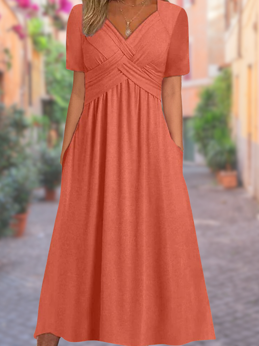 Dames zomerjurk met v-hals en korte mouwen in oranje kleur, comfortabel en stijlvol