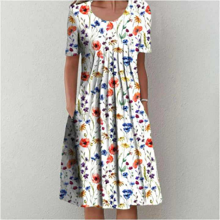 Vrolijke dames zomerjurk met bloemenprint en v-hals. Elegante midi-jurk, luchtig en casual, perfect voor de zomer.