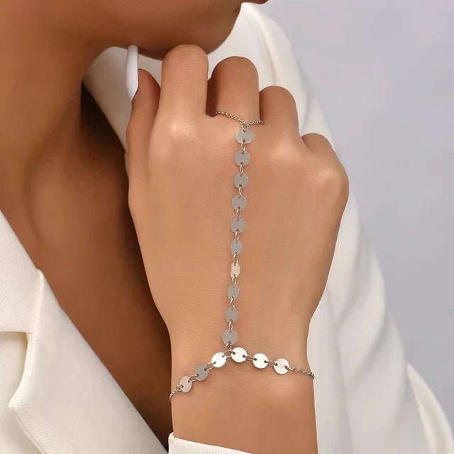 Dames handketting Aurelia van goud, een verstelbare armband met ring die sierlijk de hand siert.