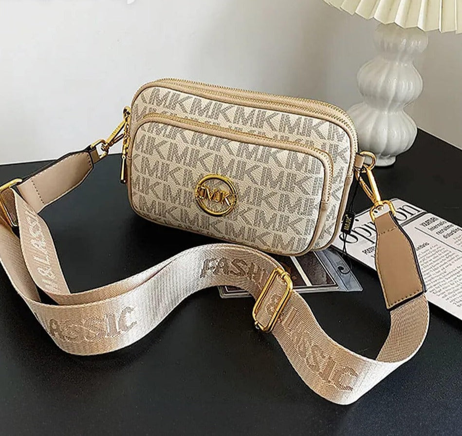 Elegante dames schoudertas in beige getoond met brede schouderriem
