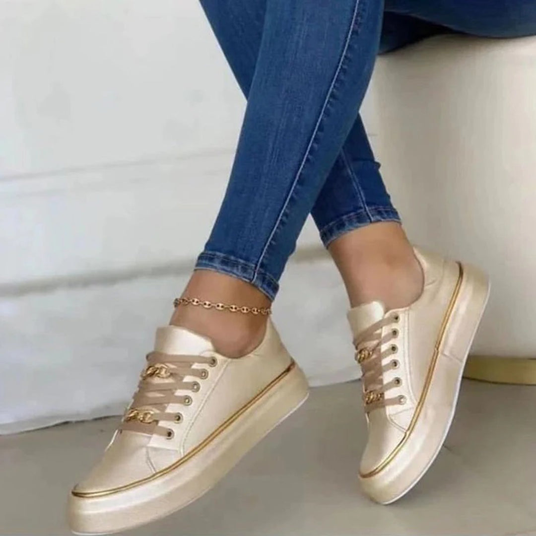 Luxe gouden damesschoenen gecombineerd met een blauwe spijkerbroek