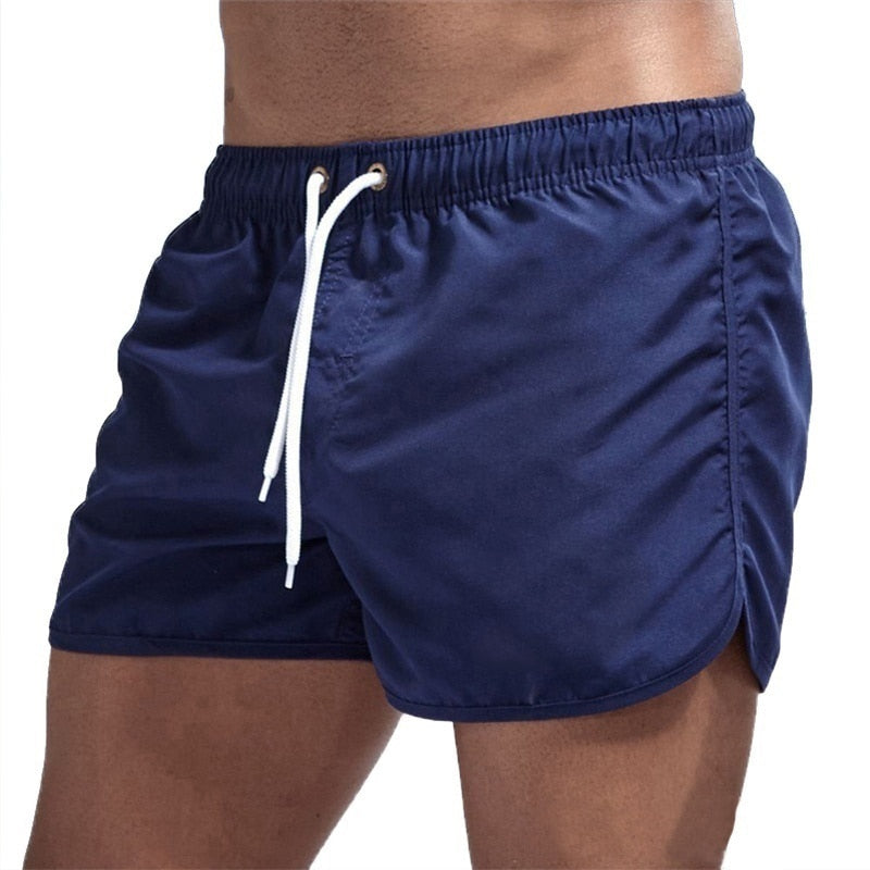 Heren Ryan zwemshort bij een zwembad, klaar voor een duik. Stijlvolle en functionele zwemkleding voor heren.