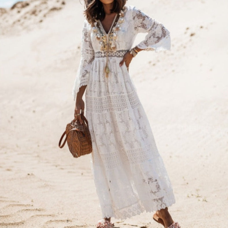 Elegante witte dames maxi jurk met lange mouwen en rieten tas