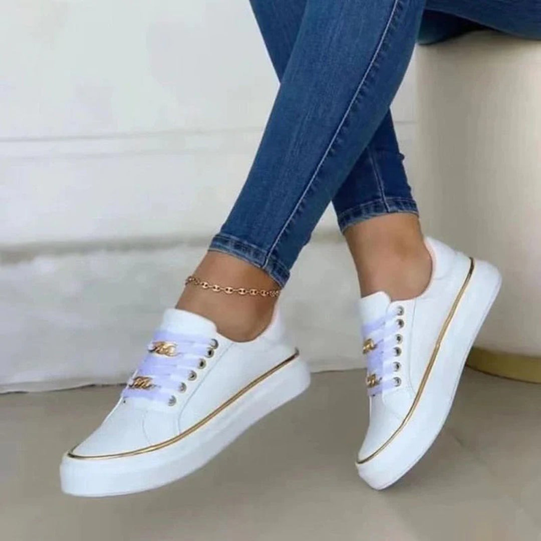 Elegante witte sneakers voor dames met chique goudaccenten