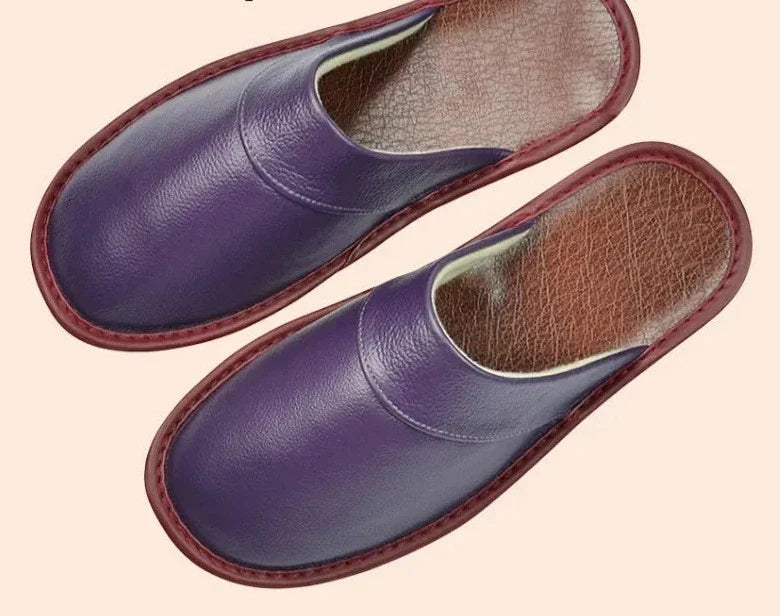Paar luxe heren pantoffels met gesloten neus op houten vloer, klaar voor ontspanning thuis.