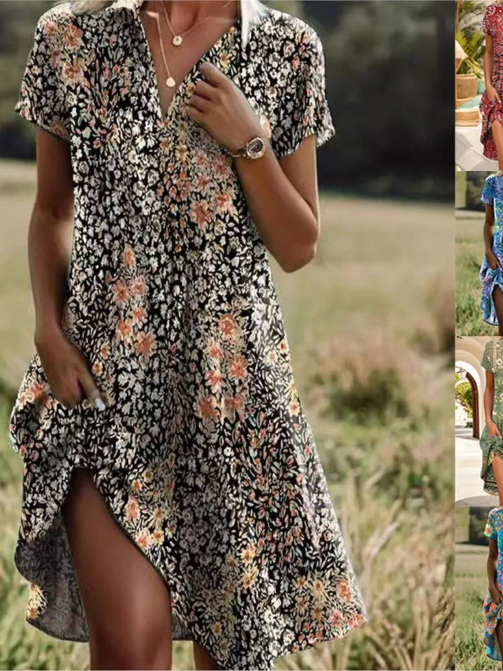 Model draagt een stijlvolle bloemen overhemd mini jurk met V-hals, lange mouwen. Elegante zomerjurk dames.
