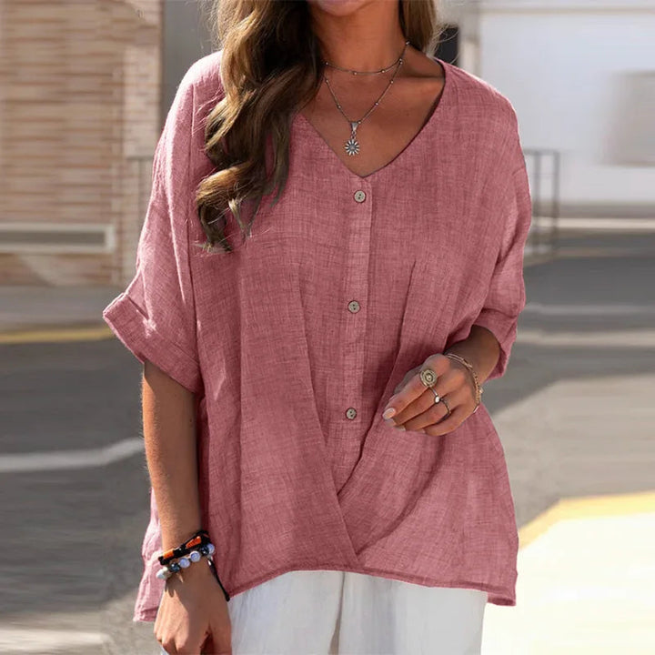 Moderne damesblouse met V-hals, oprolmouwen, effen design; combineert comfort met een trendy, elegante uitstraling.