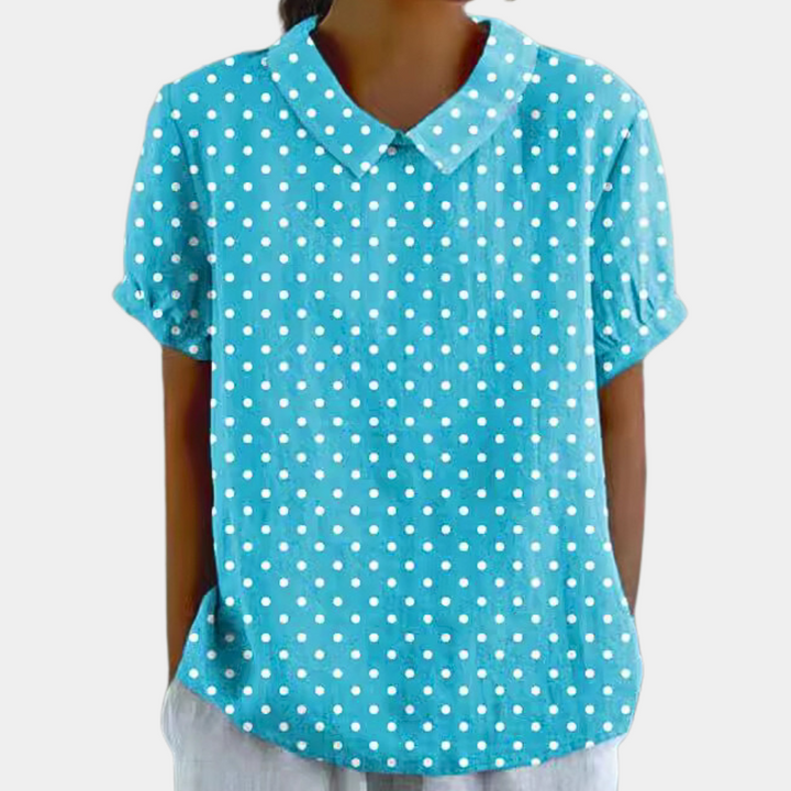Veelzijdige damesbloes met levendige bloemenprint, korte mouwen en kraag. Geschikt voor casual en elegante outfits.