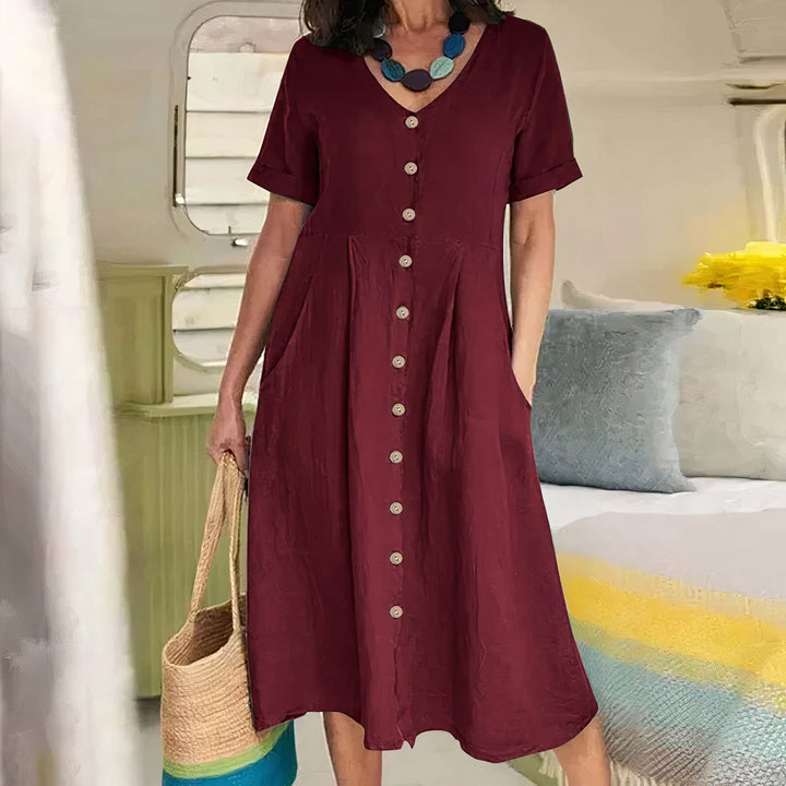 Dames casual midi jurk met V-hals, knoopdetail en zijzakken voor een zomerse look.