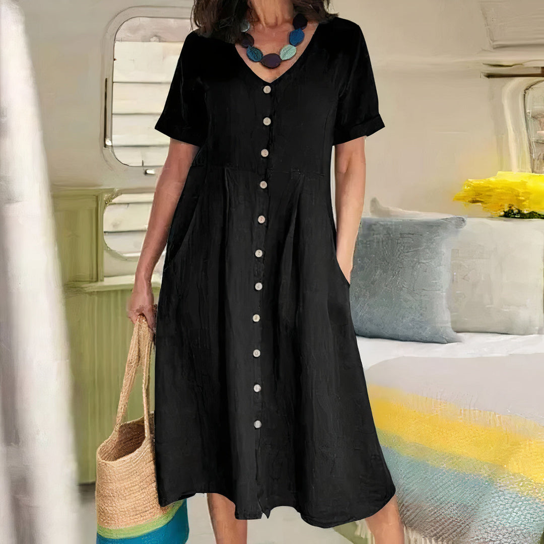 Comfortabele dames midi jurk met V-hals, praktische zijzakken en decoratief knoopdetail.