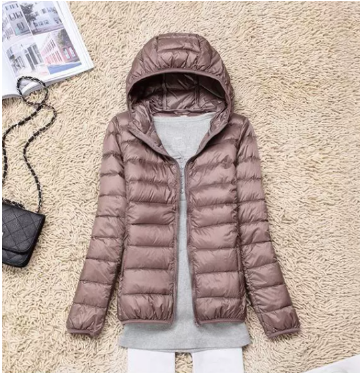 Elegante crèmewitte gewatteerde jas met capuchon voor dames, biedt een lichte en moderne look.