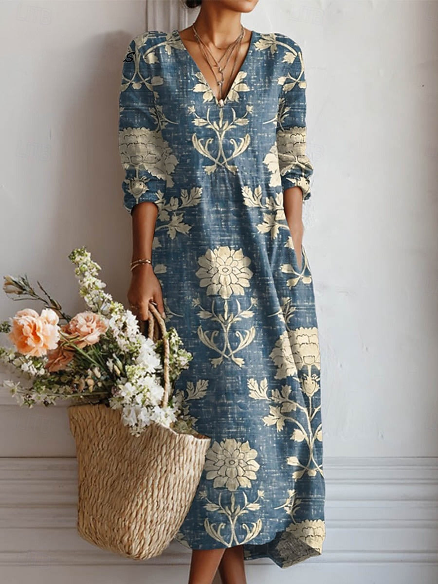 Dames maxi jurk met lange mouwen en V-hals, voorzien van een elegante bloemenprint. Comfortabele casual boho stijl.