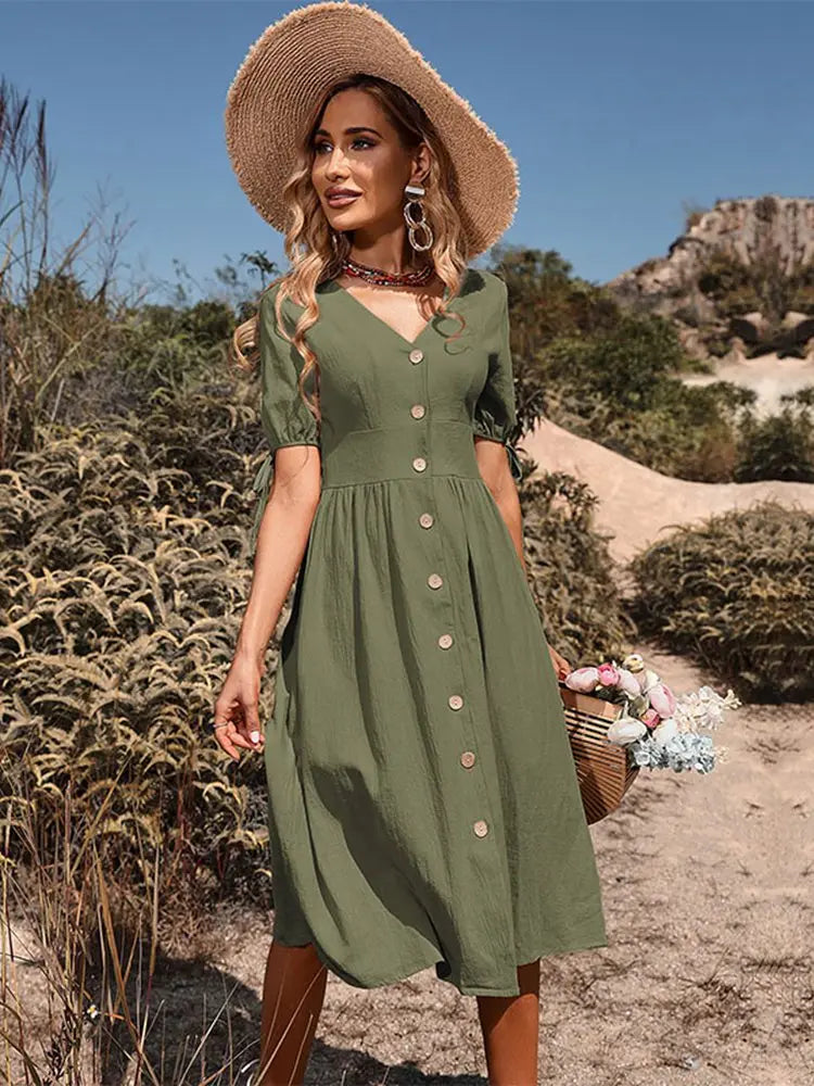 Dames midi zomerjurk met V-hals en knoopsluiting. Casual, comfortabel en modieus voor lentemode.
