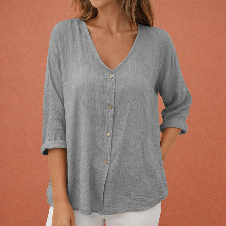 Dames blouse met elegante V-hals en driekwart mouwen, voorzien van knoopsluiting. Casual chic voor zomer/herfst.