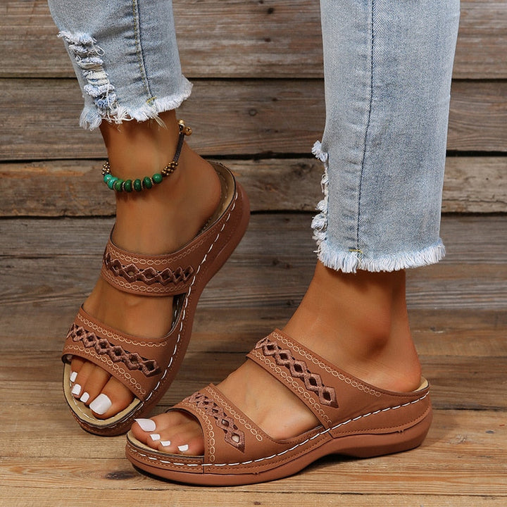 Stijlvolle dames sandalen met comfortabele wigzool en verfijnde uitgesneden details. Essentieel voor zomerse mode.