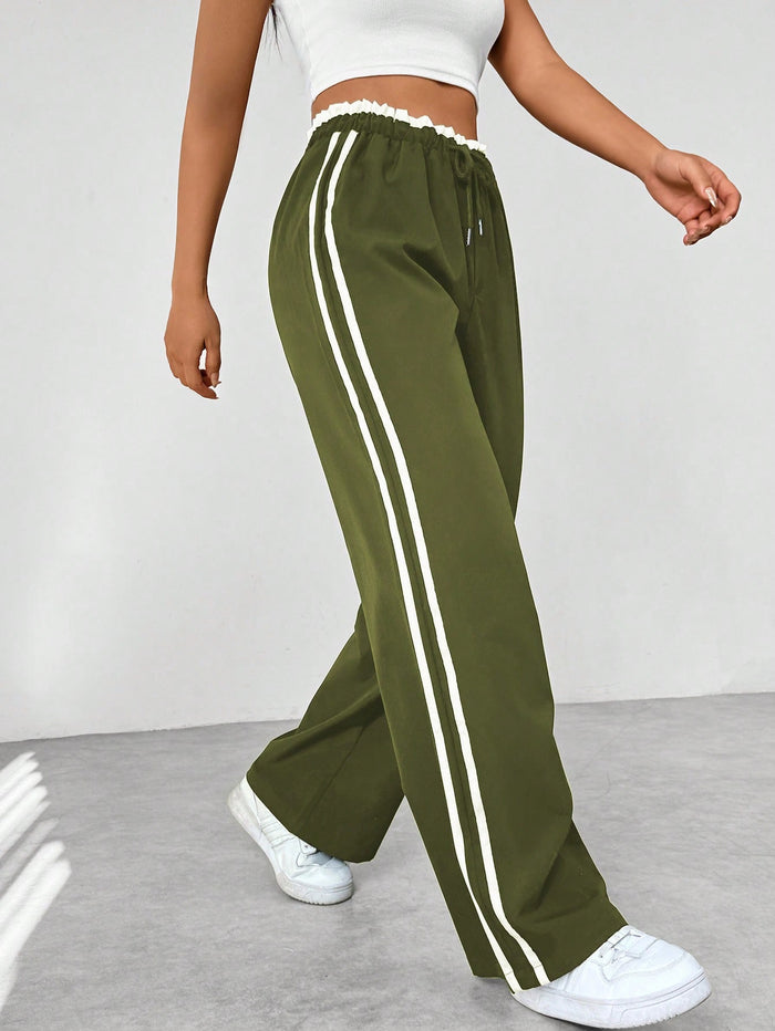 Donkerblauwe joggingbroek met witte strepen, elastische tailleband, sportief en trendy design, damesmode.