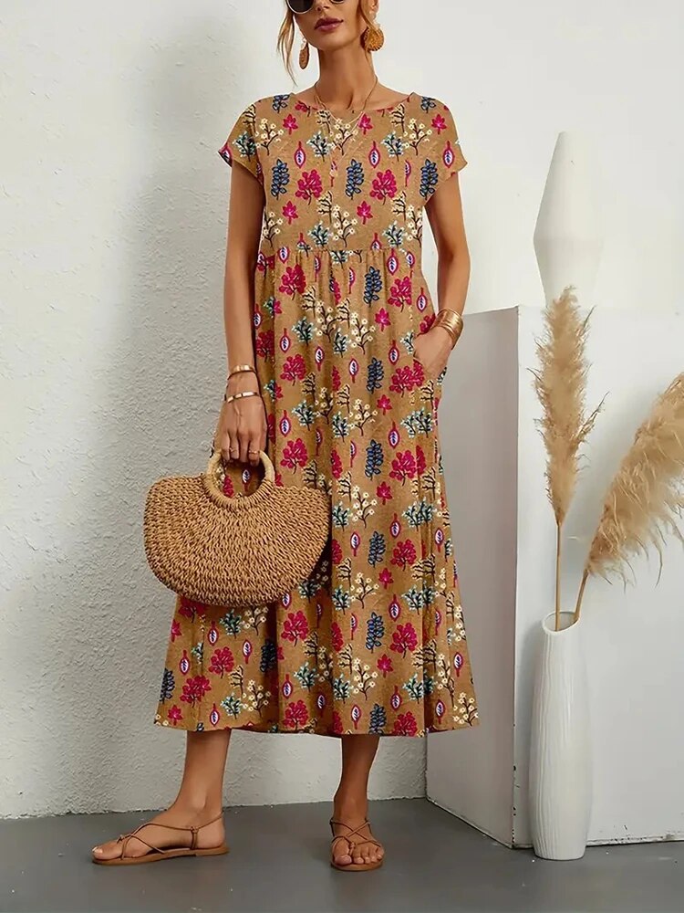 "Elegante A-lijn zomerjurk met kleurrijke bloemenprint, korte mouwen en lange rok, gemaakt van licht katoenen stof."