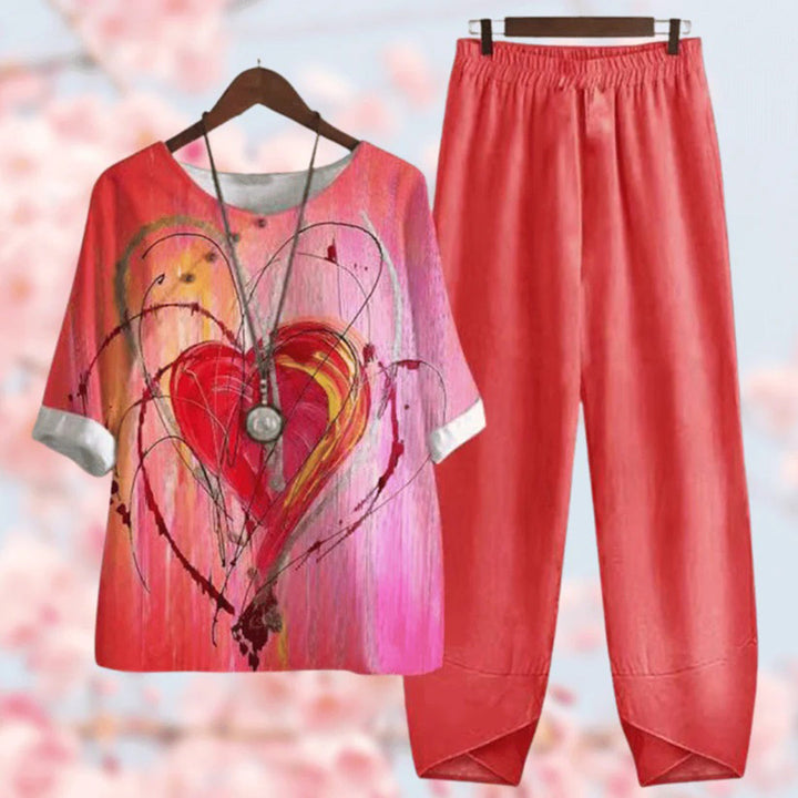 Elegante tweedelige set met vintage bloemenprint, losse top met korte mouwen en high-waist broek, stijlvol en comfortabel.