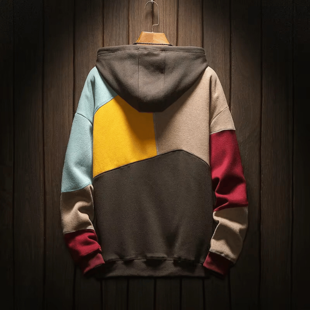 Detail van het unieke en kleurrijke patchwork patroon op de heren hoodie.