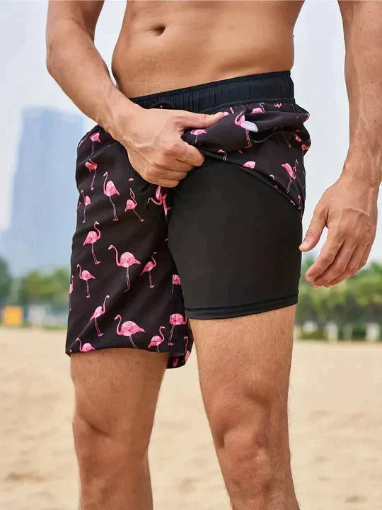 Stijlvolle zwarte herenzwembroek met roze flamingo print en comfortabele binnenbroek