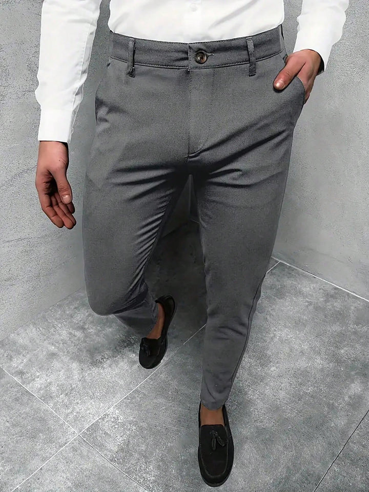Heren broek Jasper in het grijs getoond in frontaal perspectief met riemlussen en knoop