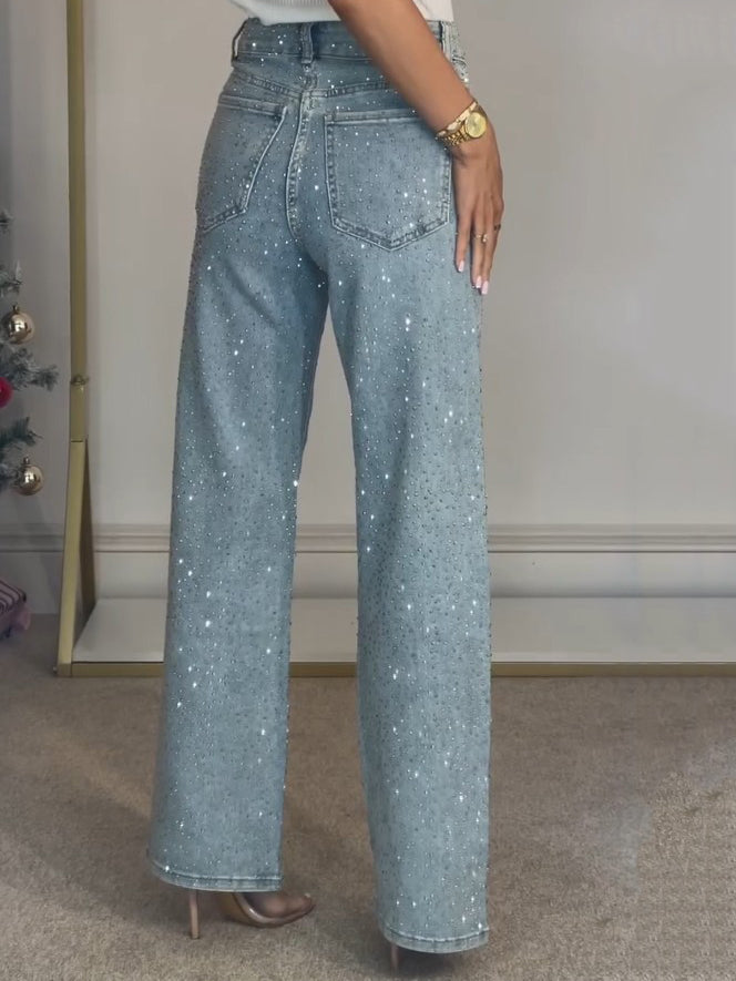 Elegante dames flared broek met wijde pijpen en hoge taille, uitgevoerd in lichtblauw met subtiele glinsters.