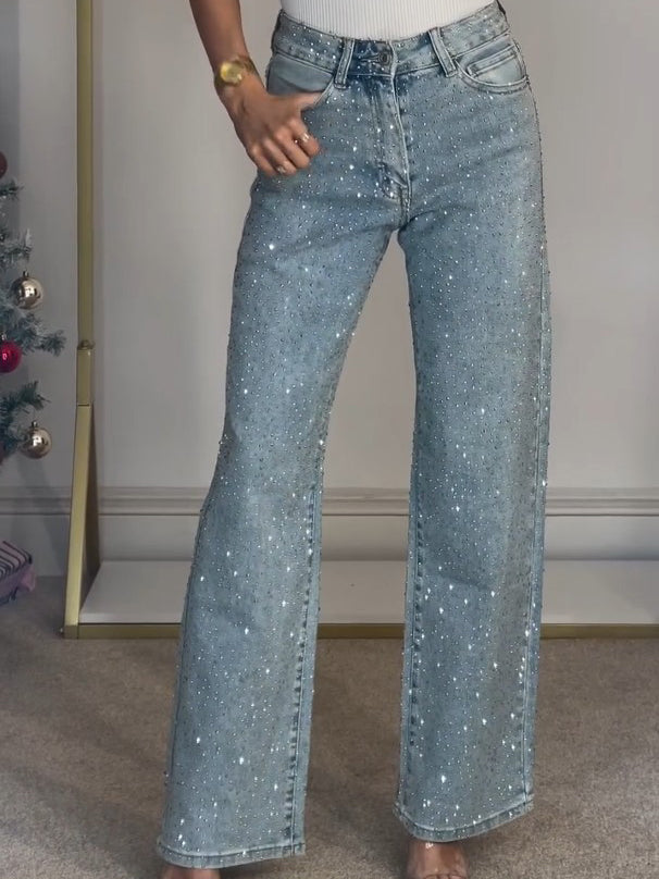 Glinsterende lichtblauwe dames flared broek met hoge taille; een trendy en feestelijke elegantejeans.