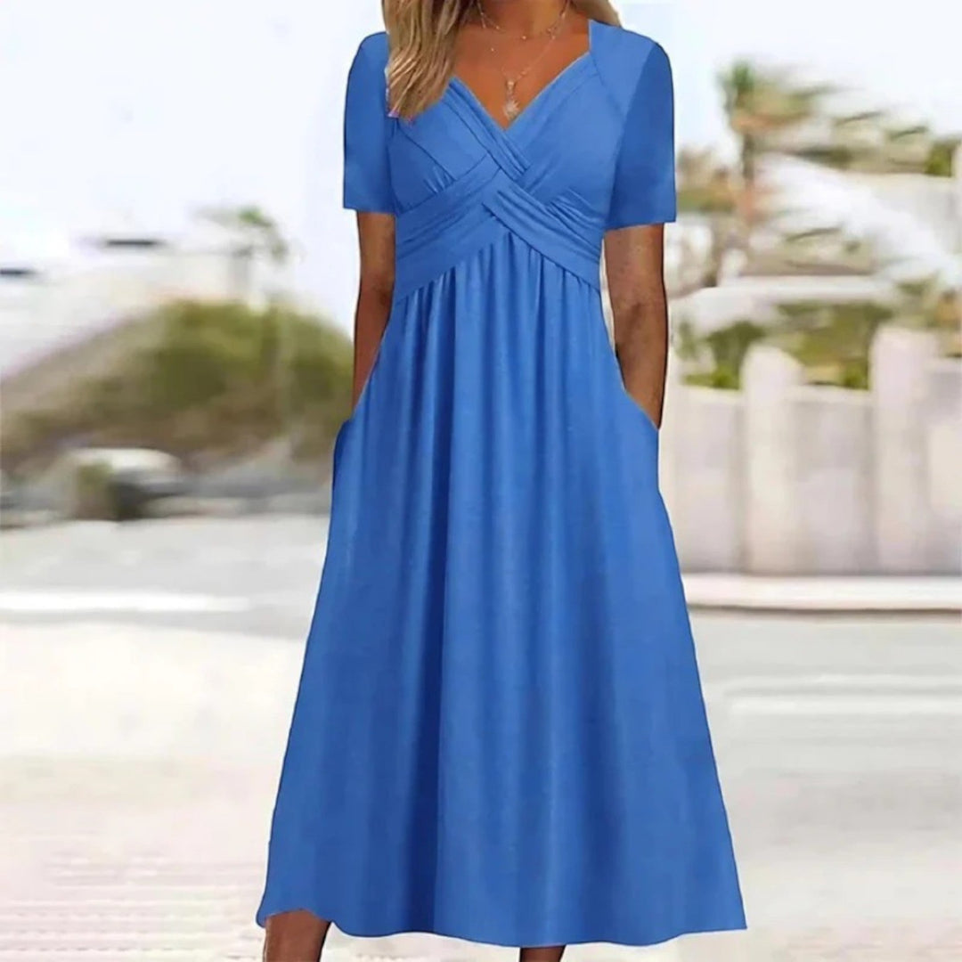 "Luchtige A-lijn zomerkleed met V-hals en zakken, midi lengte, voor dames in een elegante, flatterende snit."