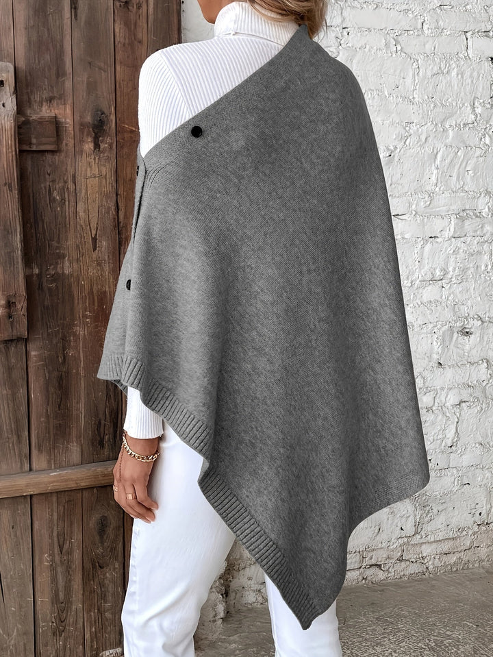 "Luxe dames poncho met elegante knoopsluiting, zacht ademend materiaal, perfect voor casual en formele outfits."