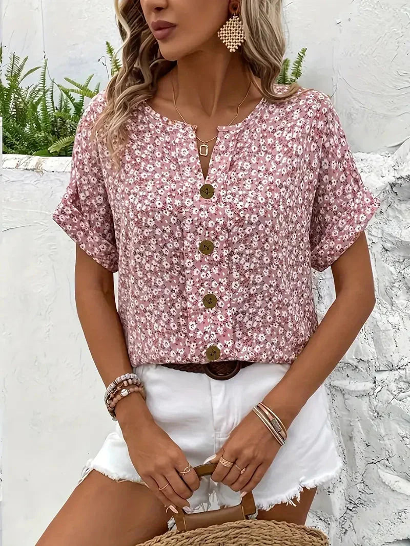 Frisse dames zomerkleding: roze blouse met levendige bloemenprint, korte mouwen en comfortabele pasvorm.
