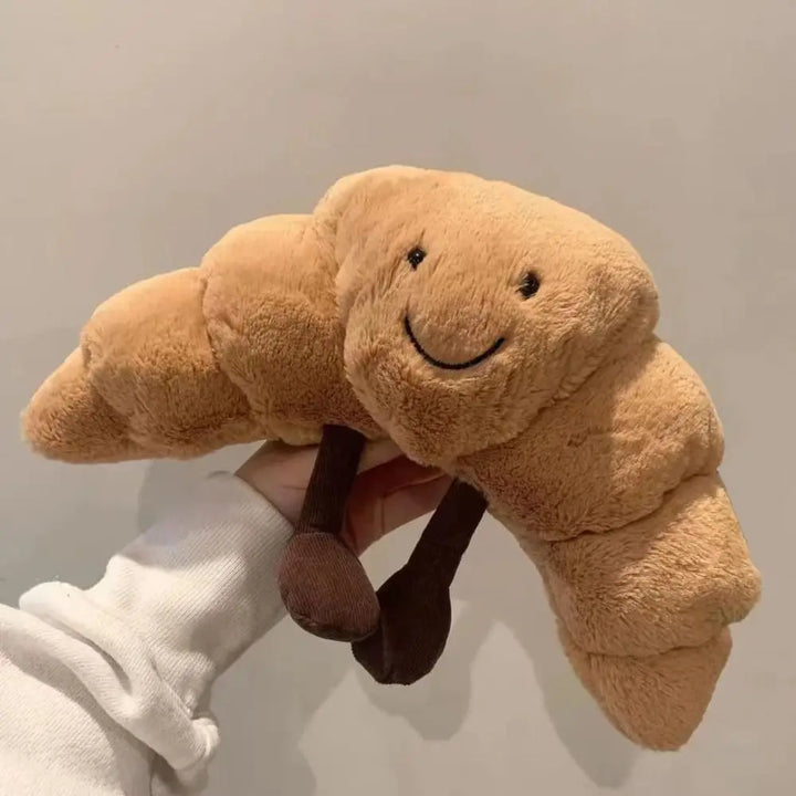 Schattige pluchen croissant knuffel met lachend gezicht, kort pluche en PP-katoen, perfecte decoratie of cadeau.