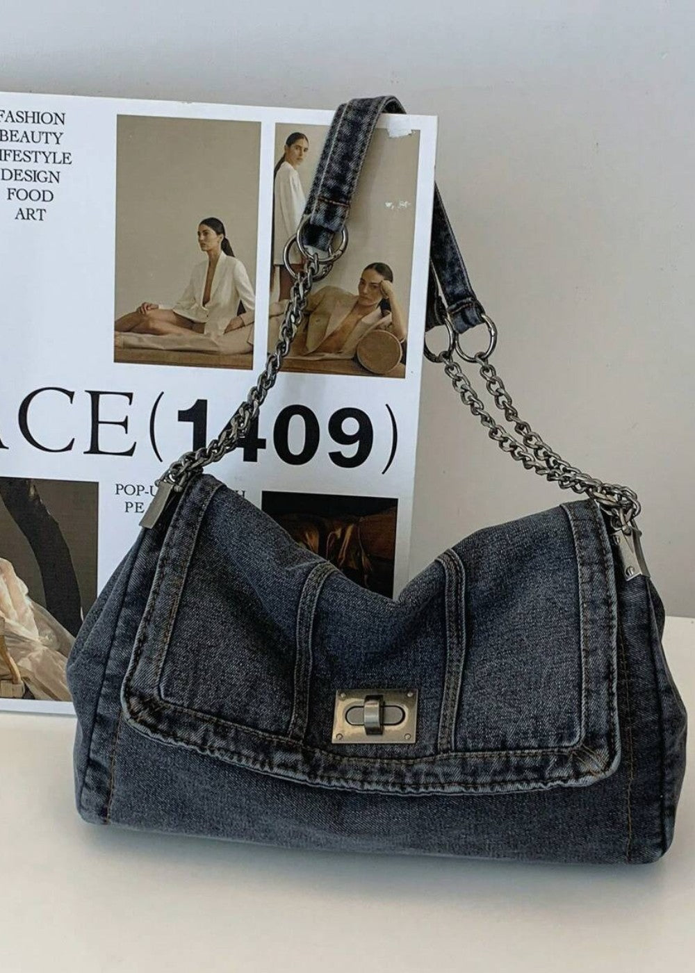 Detailopname van een trendy dames denim kettingtas, accentueert het urban design.