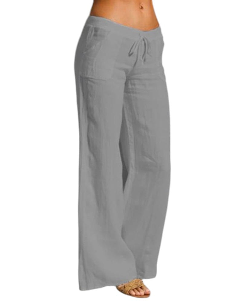 Vrouw draagt elegante, luchtige linnen broek met elastische taille in zwart. Perfect voor casual en formele gelegenheden.