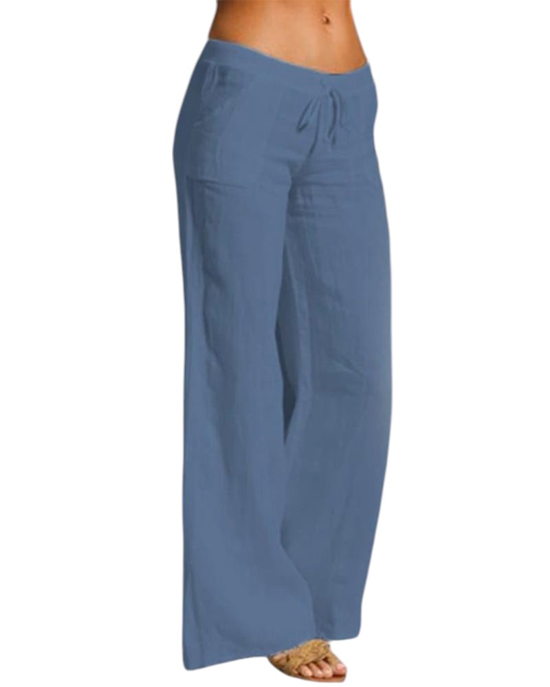Vrouw draagt elegante, luchtige linnen broek met elastische taille in zwart. Perfect voor casual en formele gelegenheden.