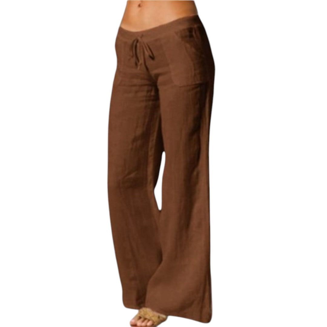 Vrouw draagt elegante, luchtige linnen broek met elastische taille in zwart. Perfect voor casual en formele gelegenheden.