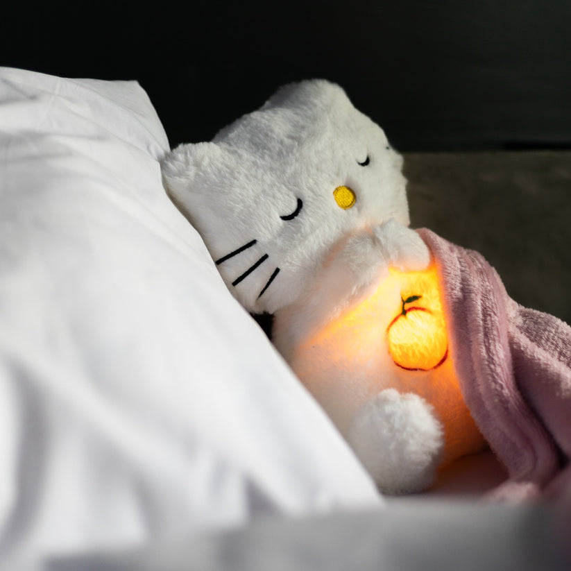 "Zachte knuffel met ingebouwd nachtlampje en geluiden in pastelkleuren voor stressverlichting en ontspanning."